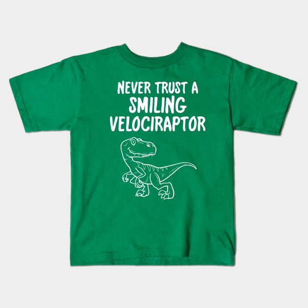 Never Trust A Smiling Velociraptor Funny Dinosaur Kids T-Shirt by FlashMac